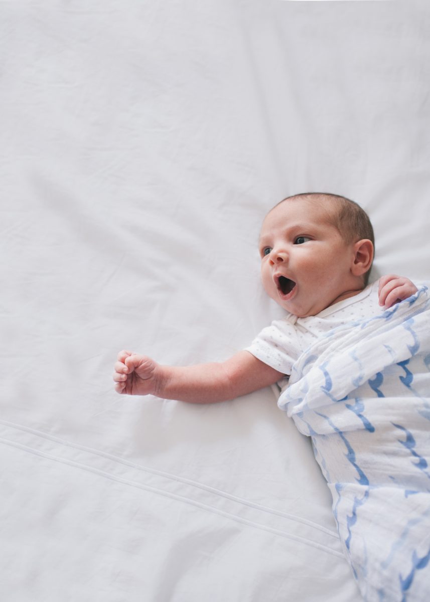 Photographers in Greensboro NC with lifestyle newborn yawning