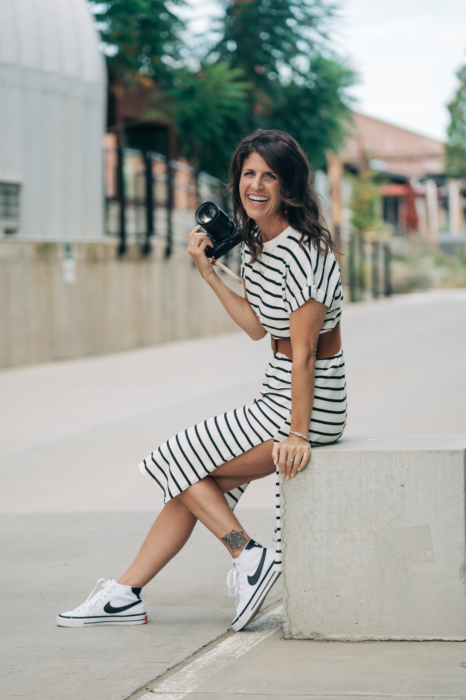 Girl in striped dress with camera in Charlotte