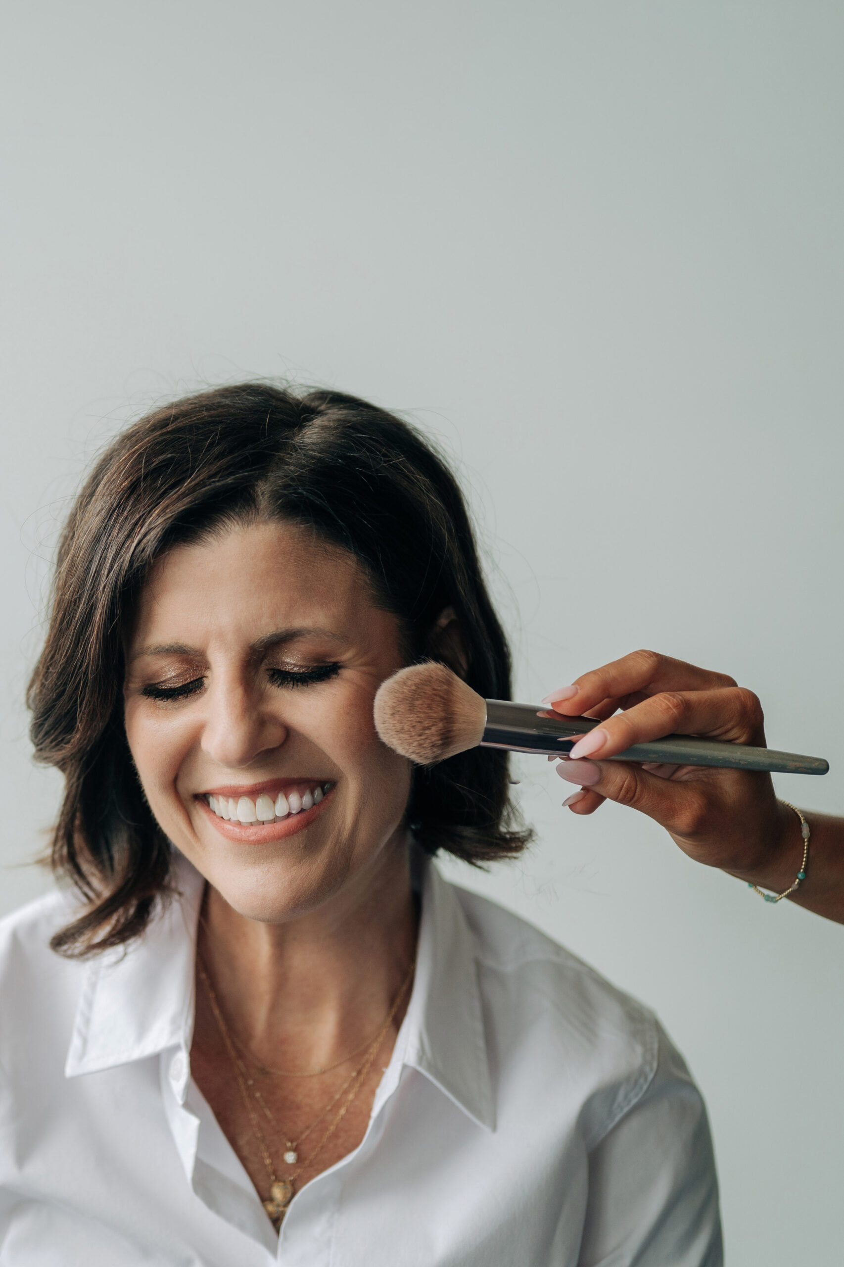 Photographer Tracy Anderson has makeup applied to cheek